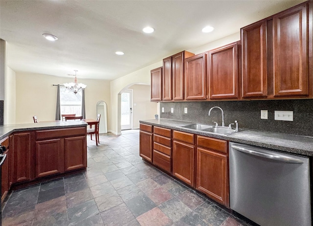 kitchen with arched walkways, a sink, stone finish floor, stainless steel dishwasher, and tasteful backsplash