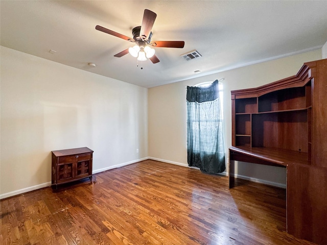 unfurnished bedroom featuring visible vents, a ceiling fan, baseboards, and wood finished floors