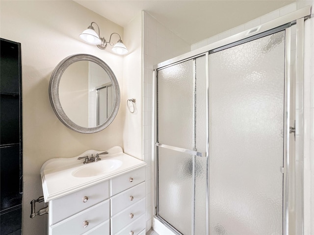 bathroom with a stall shower and vanity