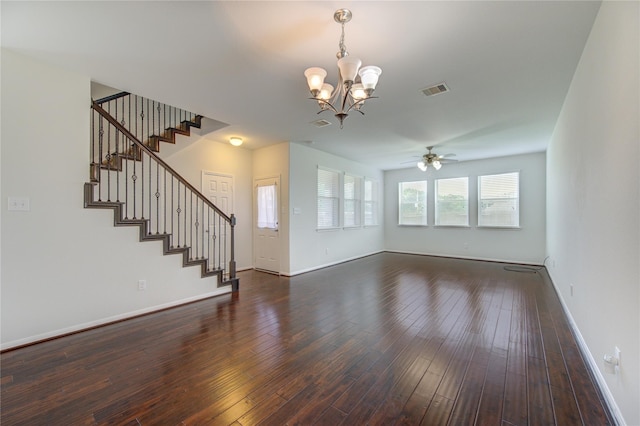 unfurnished living room featuring dark wood finished floors, visible vents, stairs, and baseboards