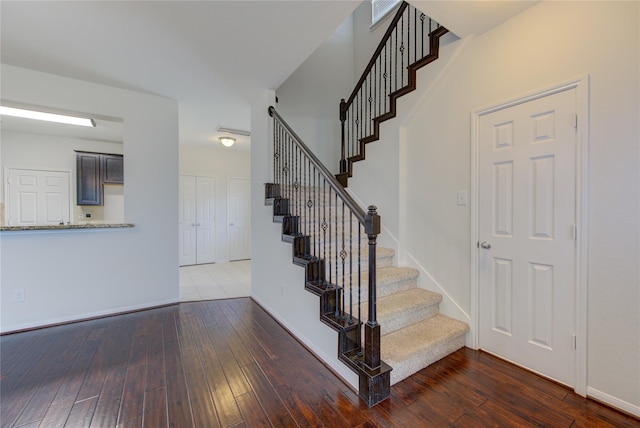 stairway with baseboards and hardwood / wood-style floors