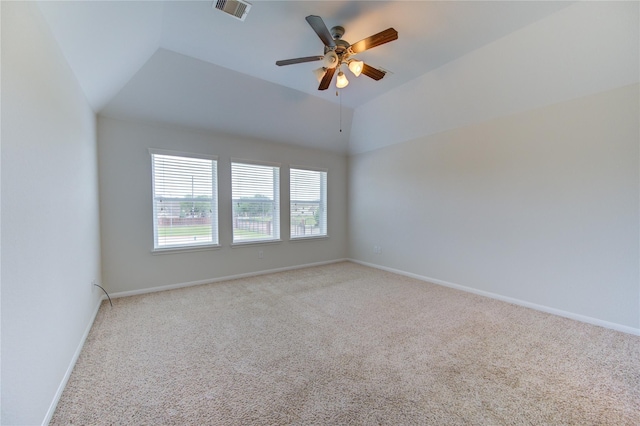 unfurnished room featuring visible vents, baseboards, light colored carpet, vaulted ceiling, and a ceiling fan