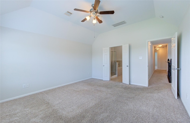 unfurnished bedroom featuring baseboards, visible vents, lofted ceiling, and light carpet