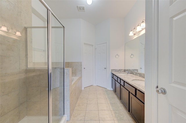 full bath featuring a shower stall, a bath, double vanity, and a sink