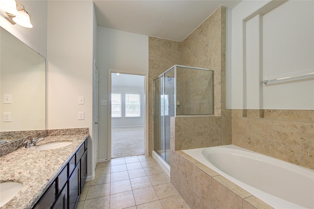 bathroom with tile patterned floors, a garden tub, a sink, a shower stall, and double vanity