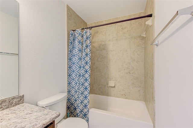 bathroom with toilet, shower / tub combo with curtain, vanity, and a textured wall