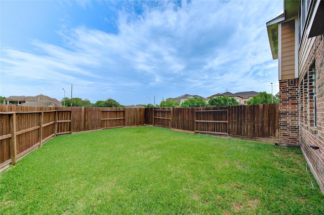 view of yard with a fenced backyard