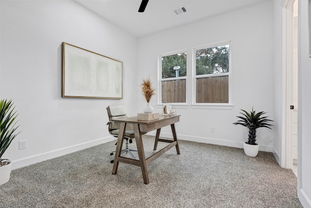 office area featuring visible vents, baseboards, ceiling fan, and carpet flooring