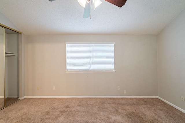 unfurnished bedroom featuring a closet, carpet, a ceiling fan, and a textured ceiling