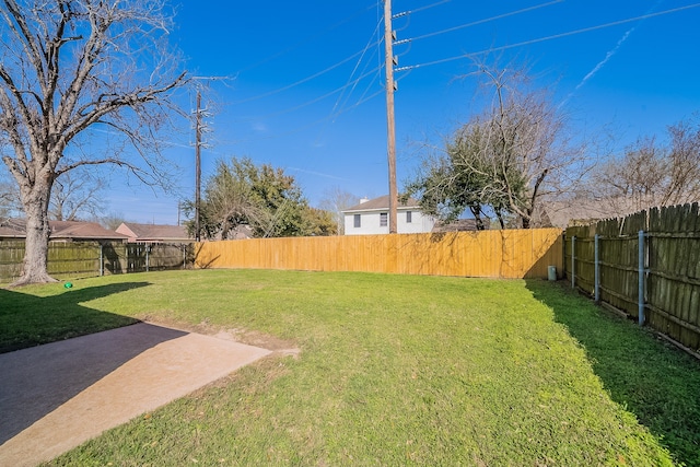 view of yard featuring a patio and a fenced backyard