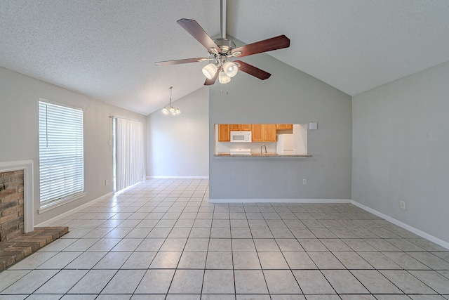 unfurnished living room with baseboards, light tile patterned floors, beam ceiling, ceiling fan with notable chandelier, and a textured ceiling