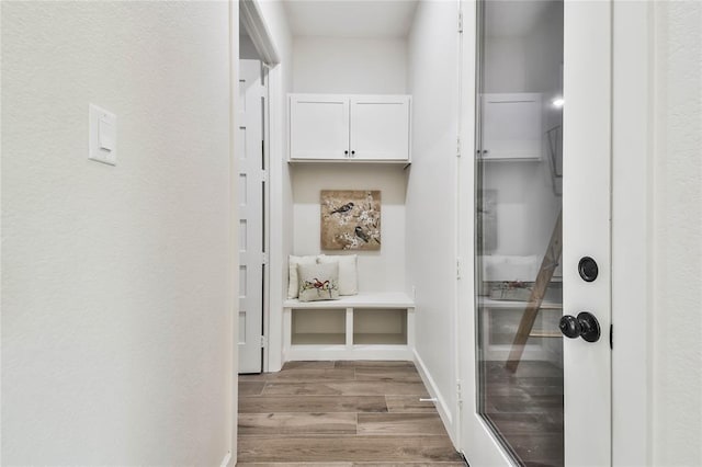 interior space with baseboards and wood finished floors