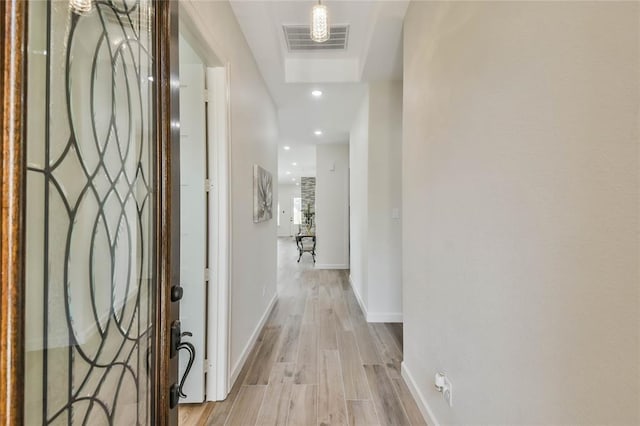 hallway featuring recessed lighting, baseboards, visible vents, and light wood-type flooring