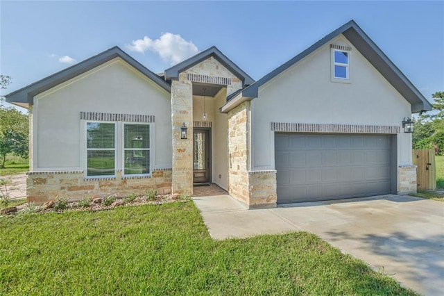 view of front of property with stucco siding, stone siding, concrete driveway, a front yard, and a garage