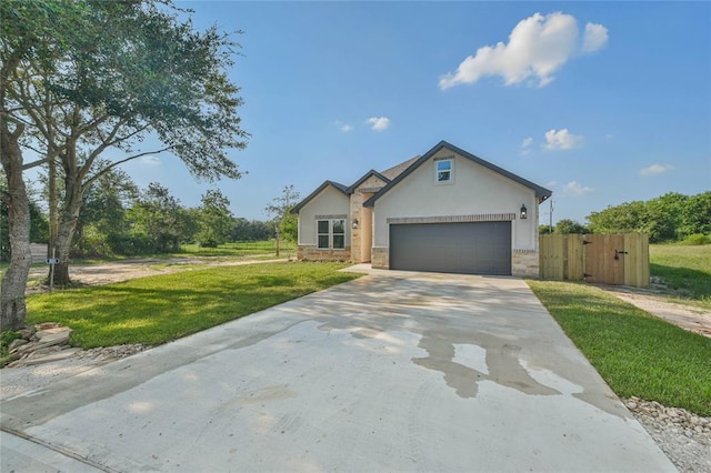 view of front of home featuring stucco siding, concrete driveway, a front lawn, a garage, and stone siding