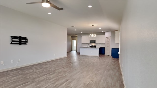 unfurnished living room with recessed lighting, baseboards, light wood-type flooring, and ceiling fan