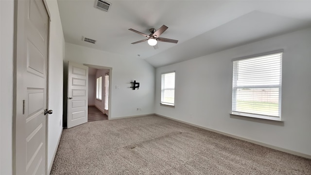 unfurnished bedroom featuring visible vents, carpet flooring, baseboards, and lofted ceiling