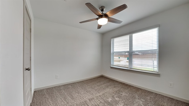 spare room featuring baseboards, carpet, and a ceiling fan