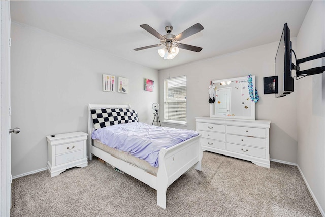 bedroom featuring ceiling fan, baseboards, and carpet