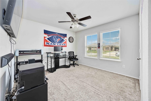 office space with ceiling fan, baseboards, and carpet