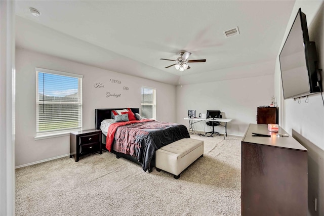 bedroom with visible vents, light carpet, baseboards, and a ceiling fan