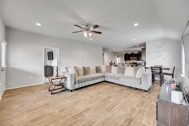 living area with light wood finished floors, recessed lighting, ceiling fan, and vaulted ceiling