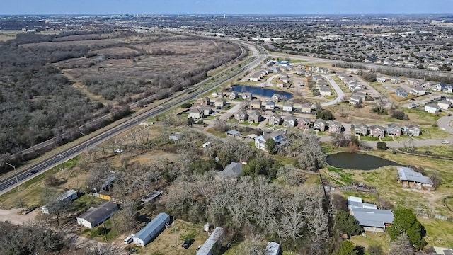 birds eye view of property with a residential view and a water view