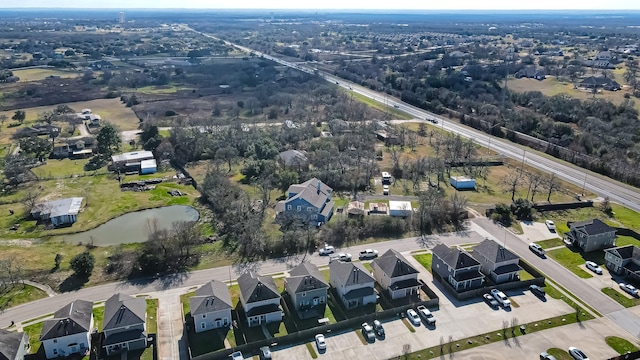 bird's eye view featuring a residential view and a water view