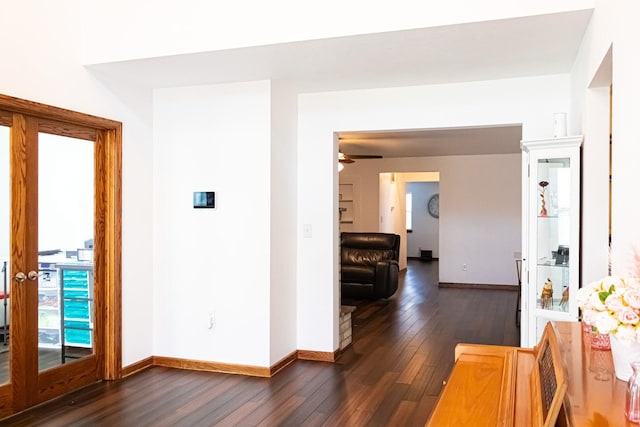 hallway with dark wood-style floors and baseboards