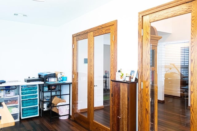 corridor with visible vents and dark wood finished floors