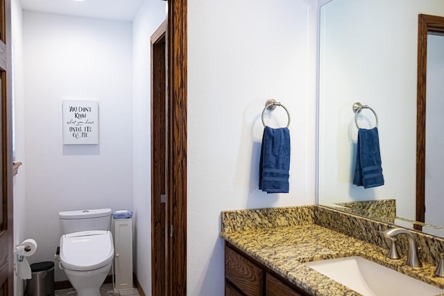 bathroom with toilet and vanity