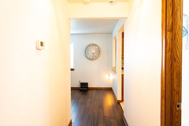 hall featuring baseboards and dark wood finished floors