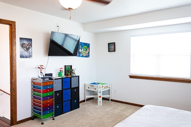 carpeted bedroom with ceiling fan and baseboards