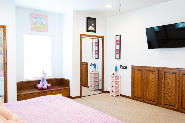 bedroom with light colored carpet and baseboards