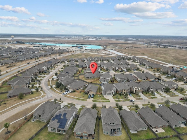 bird's eye view with a residential view and a water view