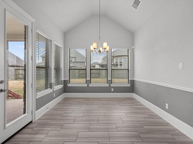 unfurnished dining area featuring visible vents, baseboards, an inviting chandelier, and vaulted ceiling