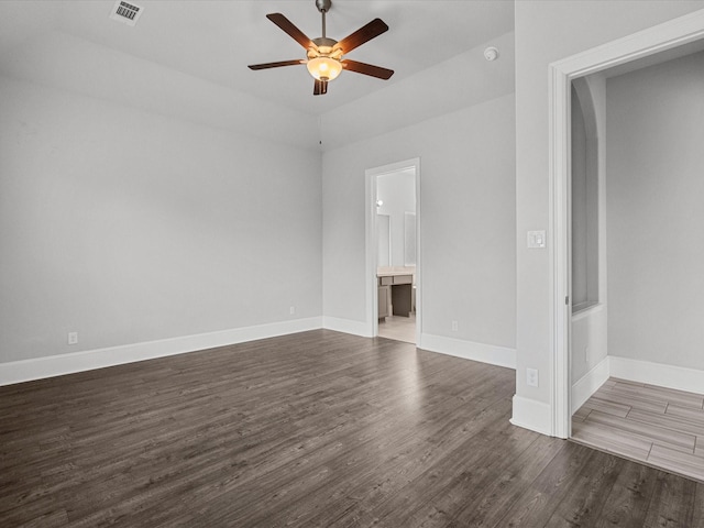 unfurnished living room featuring dark wood finished floors, baseboards, visible vents, and ceiling fan