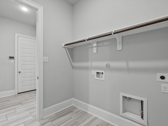 washroom featuring baseboards, hookup for an electric dryer, laundry area, washer hookup, and hookup for a gas dryer