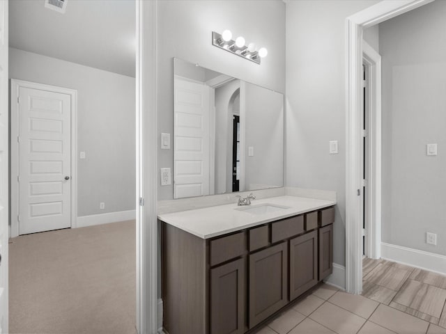 bathroom with visible vents, baseboards, and vanity