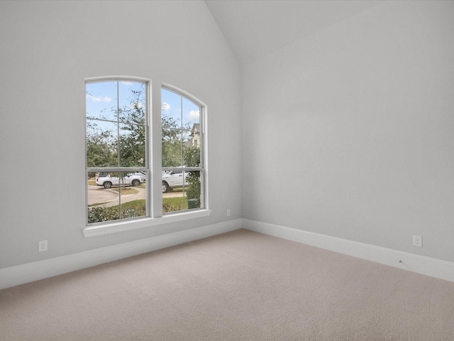 unfurnished room with baseboards, carpet floors, and lofted ceiling