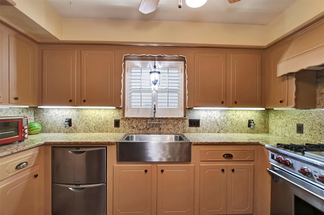 kitchen featuring ceiling fan, tasteful backsplash, appliances with stainless steel finishes, and a sink