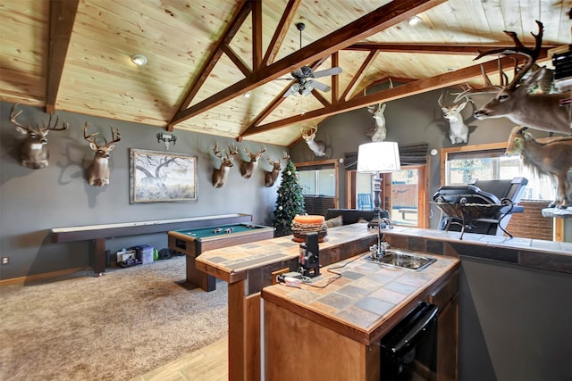 playroom featuring a ceiling fan, a sink, carpet flooring, wood ceiling, and vaulted ceiling with beams