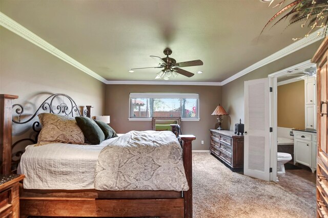 bedroom featuring carpet flooring, ensuite bathroom, baseboards, and ornamental molding