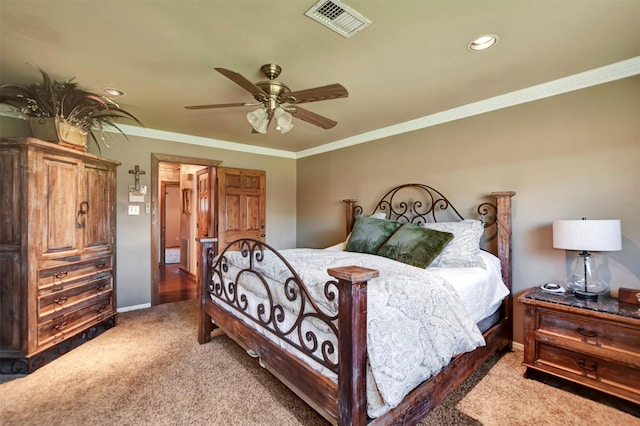 bedroom featuring a ceiling fan, baseboards, visible vents, ornamental molding, and light colored carpet