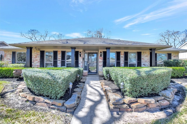 single story home with brick siding and roof with shingles