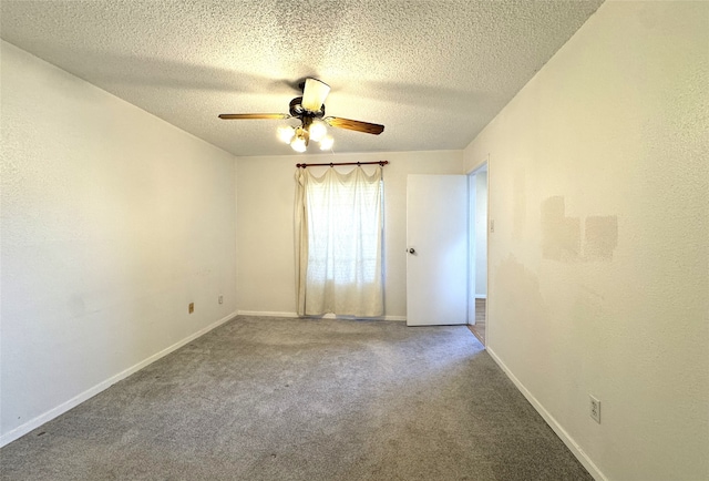 carpeted empty room with baseboards, a textured ceiling, and ceiling fan