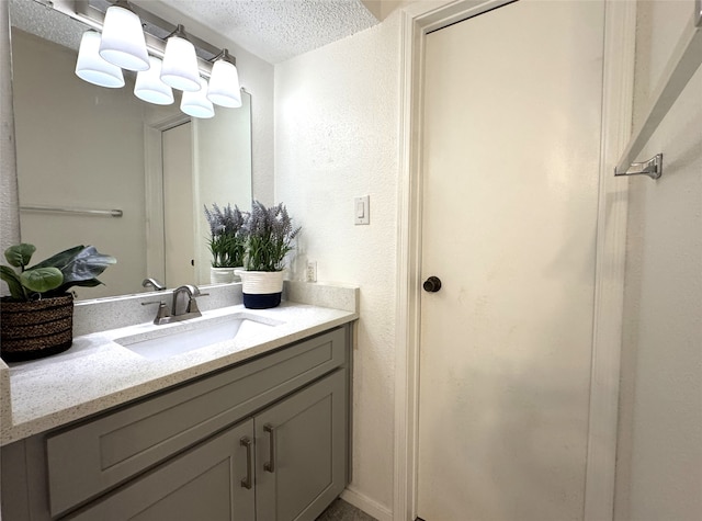 bathroom featuring vanity and a textured ceiling