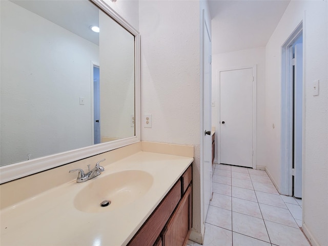 bathroom featuring tile patterned flooring and vanity