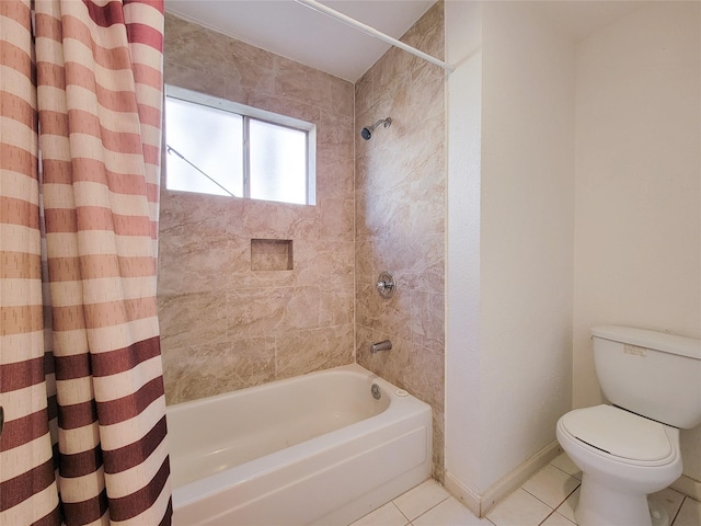 full bath with tile patterned flooring, toilet, shower / tub combo with curtain, and baseboards