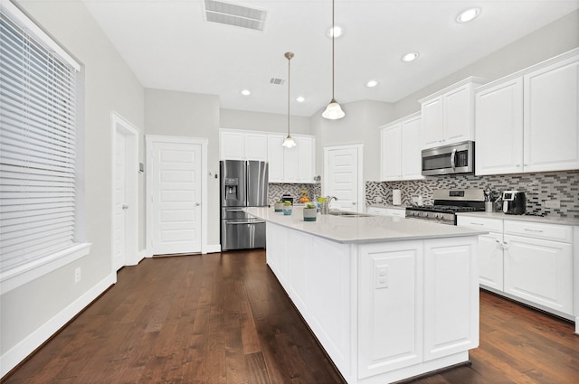 kitchen with a sink, stainless steel appliances, visible vents, and white cabinetry